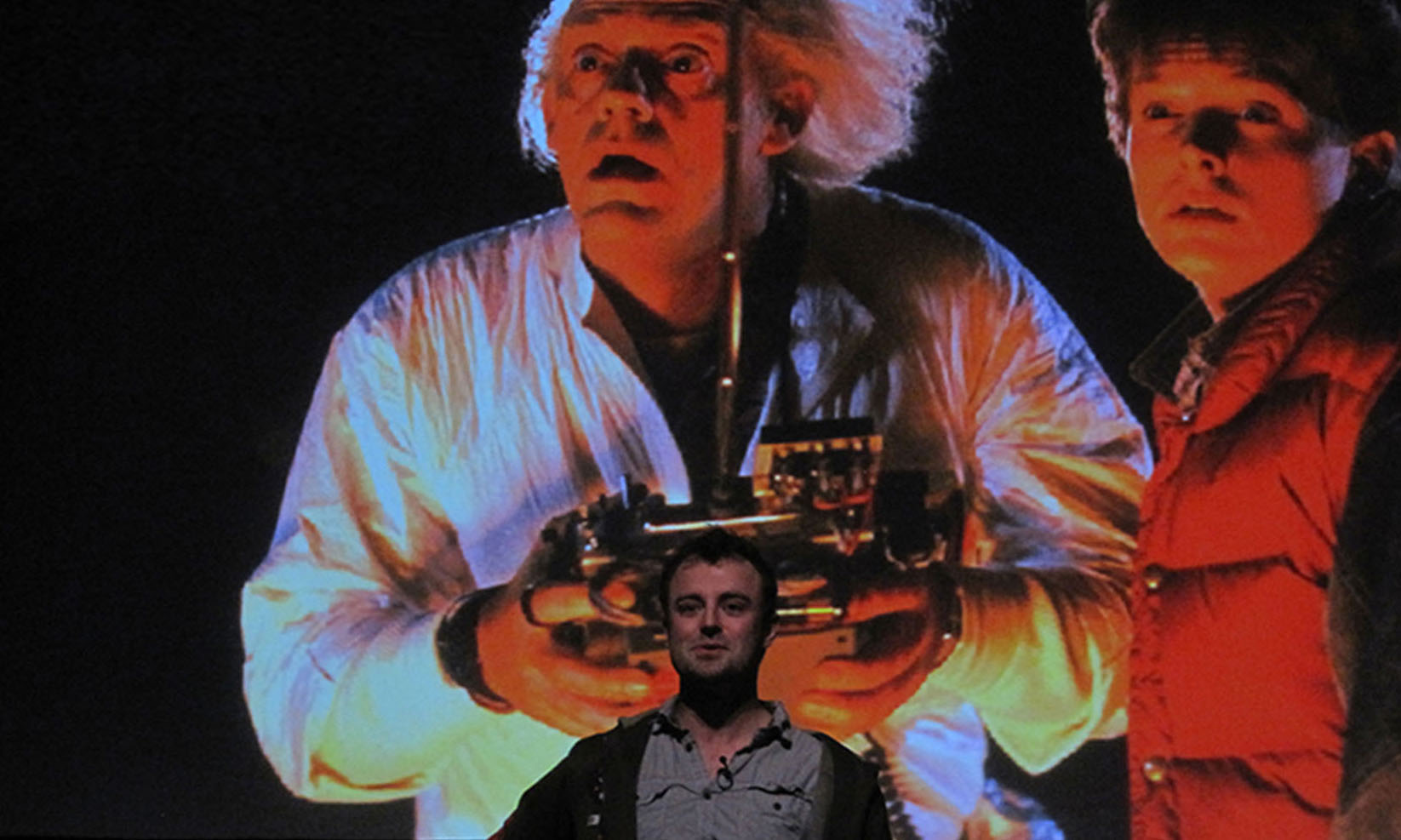 Talking in front of a Back to the Future background.